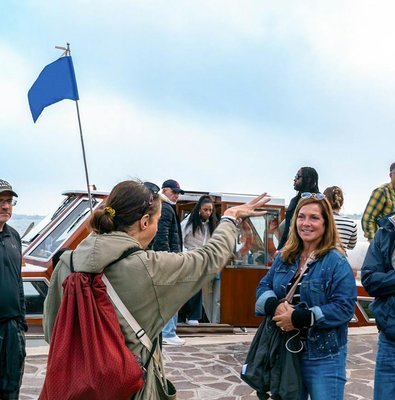 Tourists boarding a private boat for Murano and Burano Islands tour.