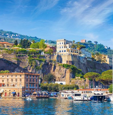 Sorrento's clifftop town and harbor seen from the sea